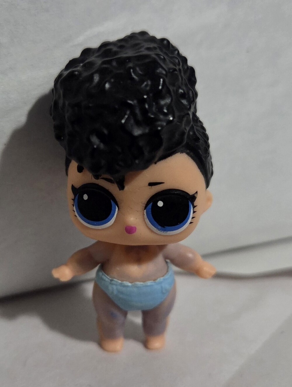 L.O.L. Surprise! Black-Haired Doll with Blue Eyes and Blue Diaper